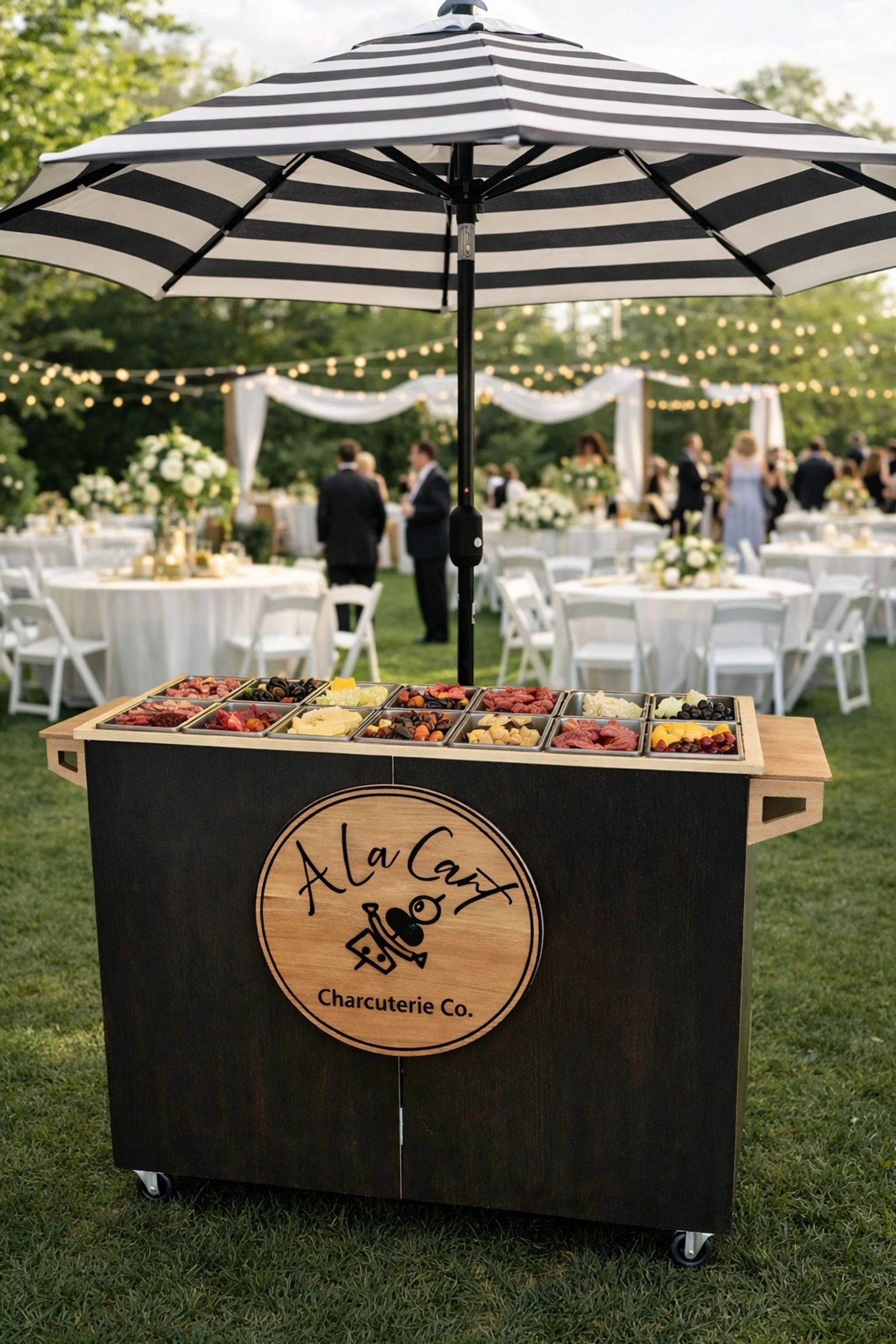 A La Cart branded charcuterie cart at an outdoor wedding in Lawrence, KS